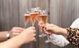 Four glasses of Bluestone sparkling rosé mid-cheers